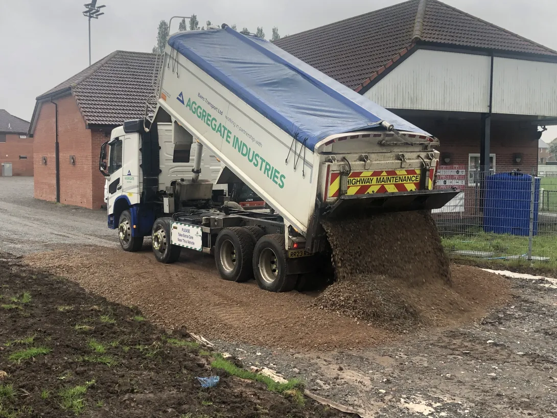 An Aggregate Industries lorry delivers materials for Coalville Town FC's new pitch and car park